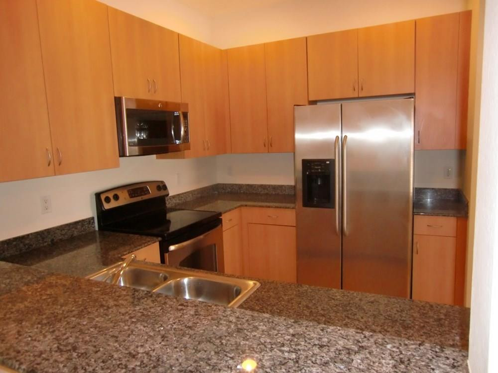 2691 Southwest 99th Way, Unit 2691 Miramar, FL 33025 - Photo 6 of 17 a kitchen with a refrigerator and a sink
