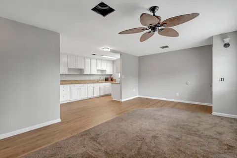 a view of a kitchen with a sink cabinets and wooden floor