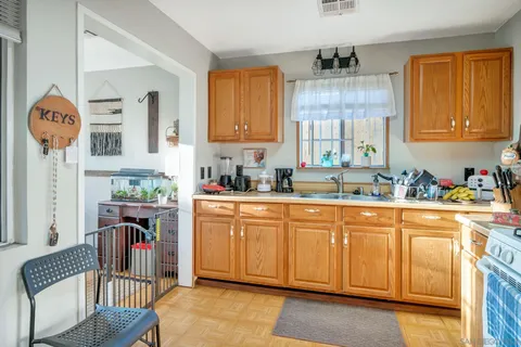 a kitchen with stainless steel appliances granite countertop a sink stove and cabinets