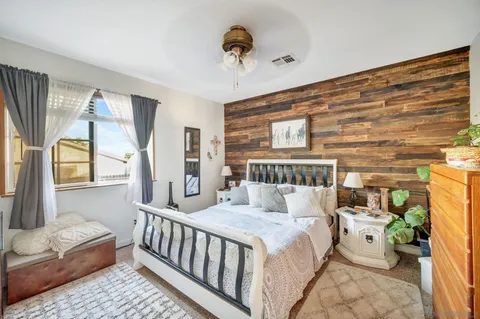 a bedroom with furniture and a flat screen tv
