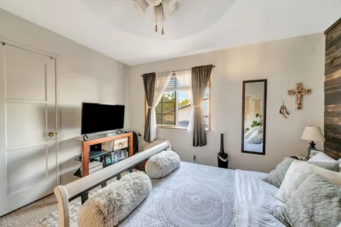 a bedroom that has a bed and a table in it