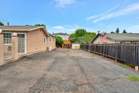 a view of a house with wooden fence