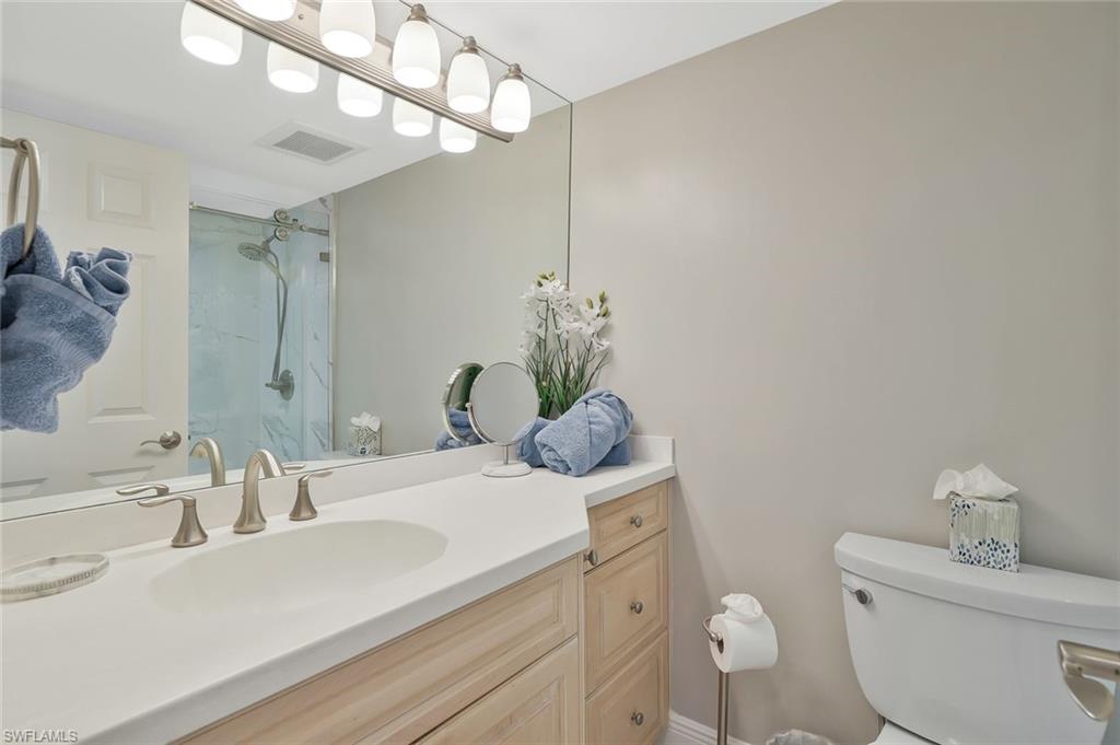 730 South Collier Boulevard, Unit 1303 Marco Island, FL 34145 - Photo 16 of 26 a bathroom with a sink a toilet and mirror
