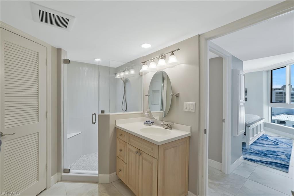 730 South Collier Boulevard, Unit 1303 Marco Island, FL 34145 - Photo 17 of 26 a bathroom with a sink mirror and a toilet