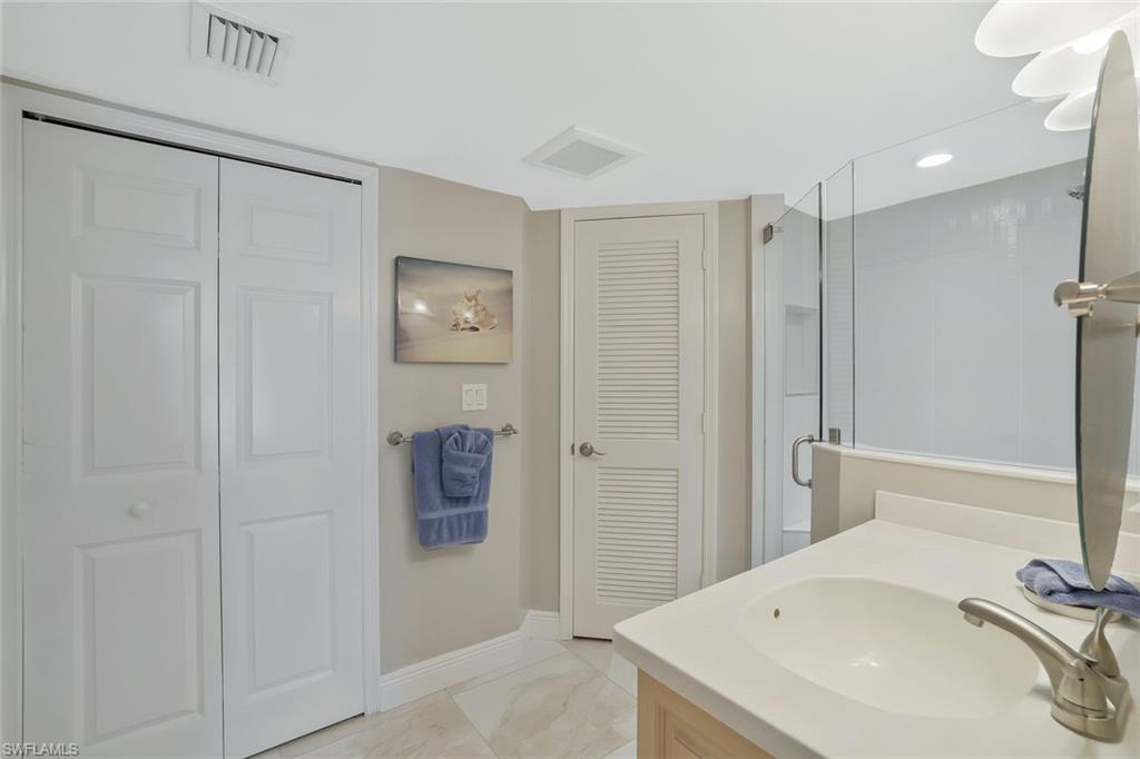 730 South Collier Boulevard, Unit 1303 Marco Island, FL 34145 - Photo 18 of 26 a bathroom with a sink and a tub