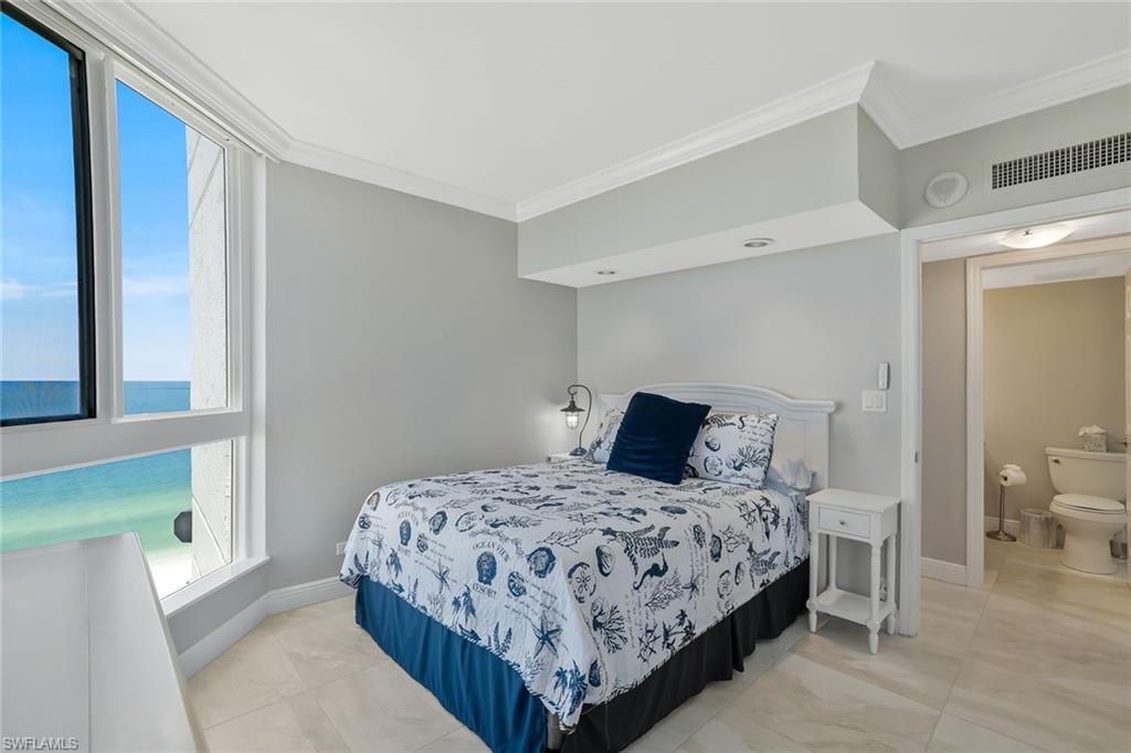 730 South Collier Boulevard, Unit 1303 Marco Island, FL 34145 - Photo 6 of 26 a bedroom with a bed and a view of bathroom