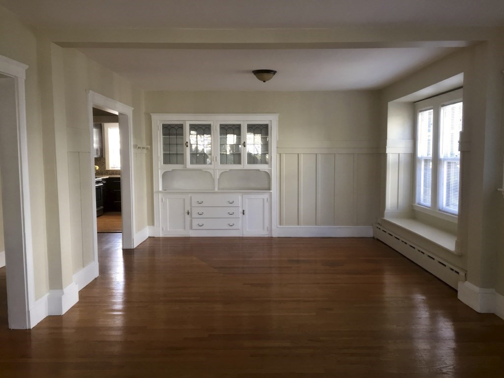 90 Orchard Street, Unit 1 Boston, MA 02130 - Photo 3 of 10 a view of an empty room with wooden floor and a window