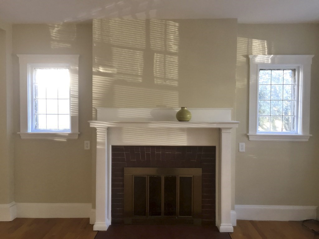 90 Orchard Street, Unit 1 Boston, MA 02130 - Photo 4 of 10 a living room with a fireplace and windows