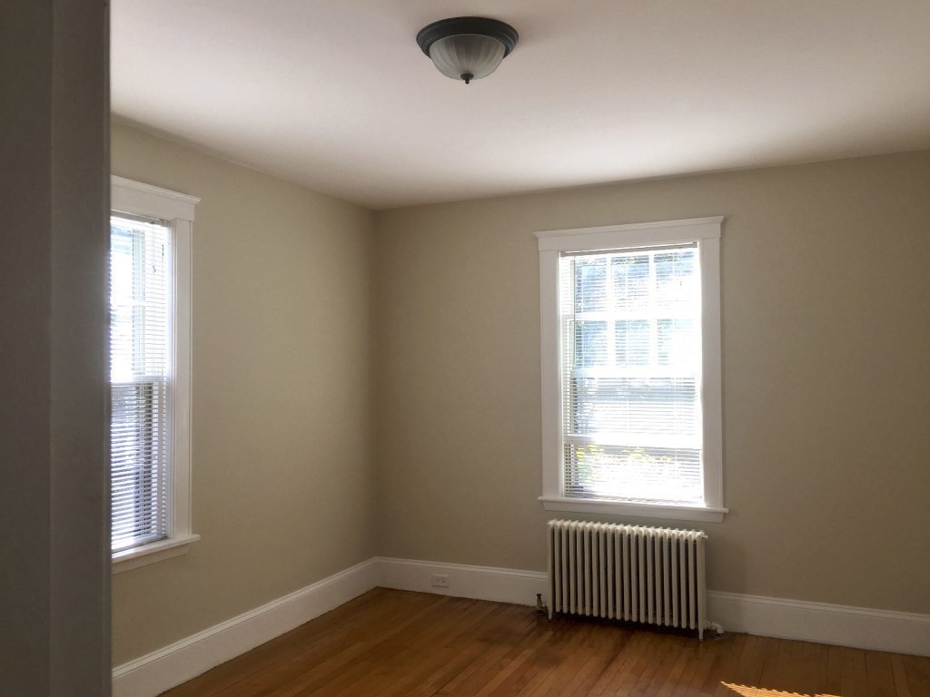 90 Orchard Street, Unit 1 Boston, MA 02130 - Photo 9 of 10 an empty room with wooden floor and windows