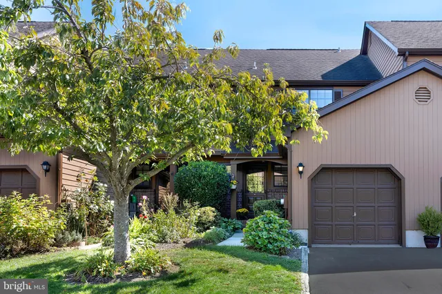 front view of a house with a tree