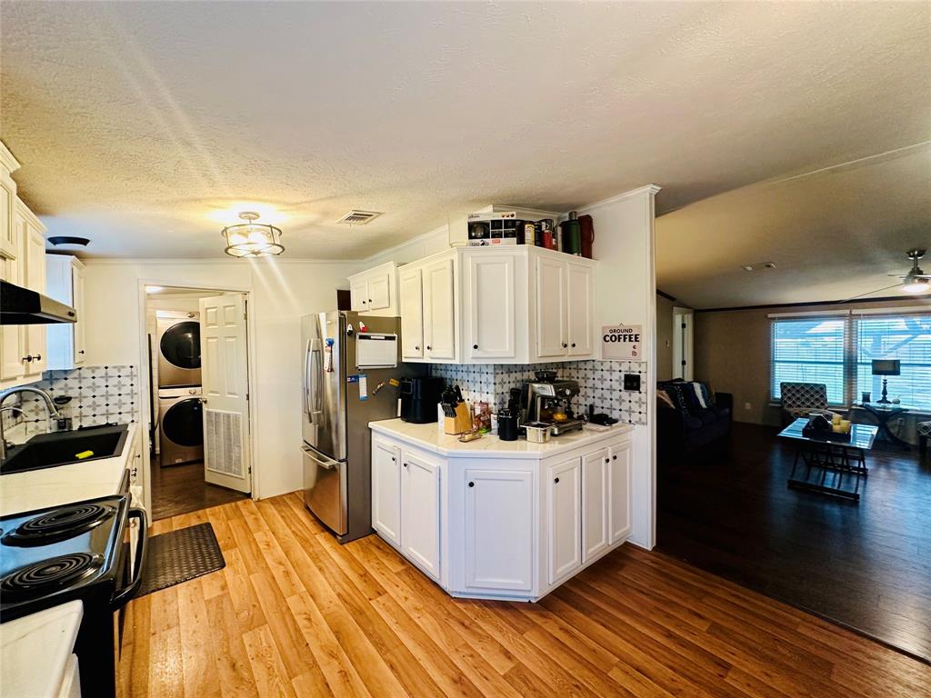 219 County Road 2723 Decatur, TX 76234 - Photo 26 of 26 a kitchen with a sink and wooden cabinets
