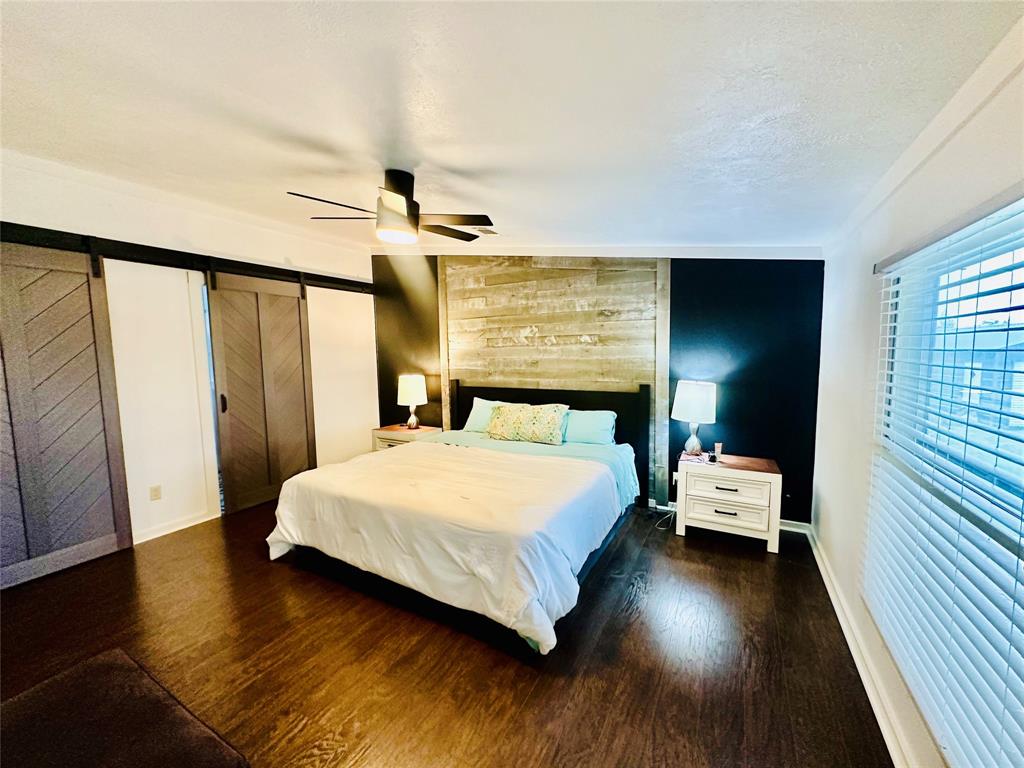 219 County Road 2723 Decatur, TX 76234 - Photo 19 of 26 a bedroom with a bed and wooden floor