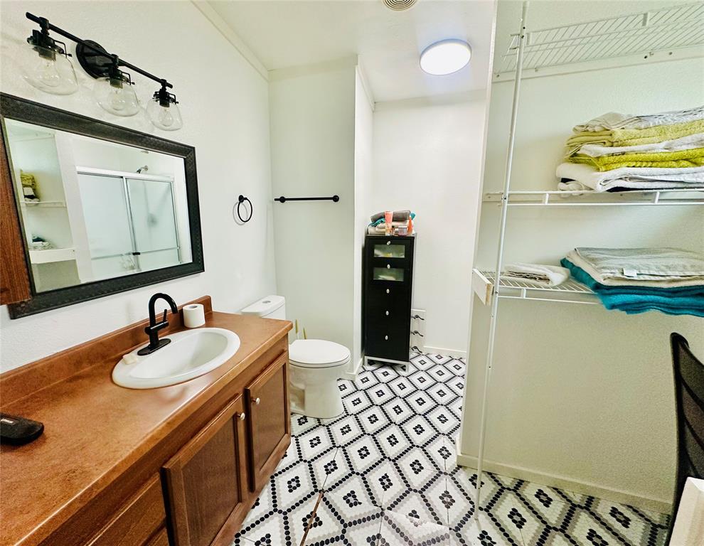 219 County Road 2723 Decatur, TX 76234 - Photo 20 of 26 a bathroom with a sink a toilet and a mirror
