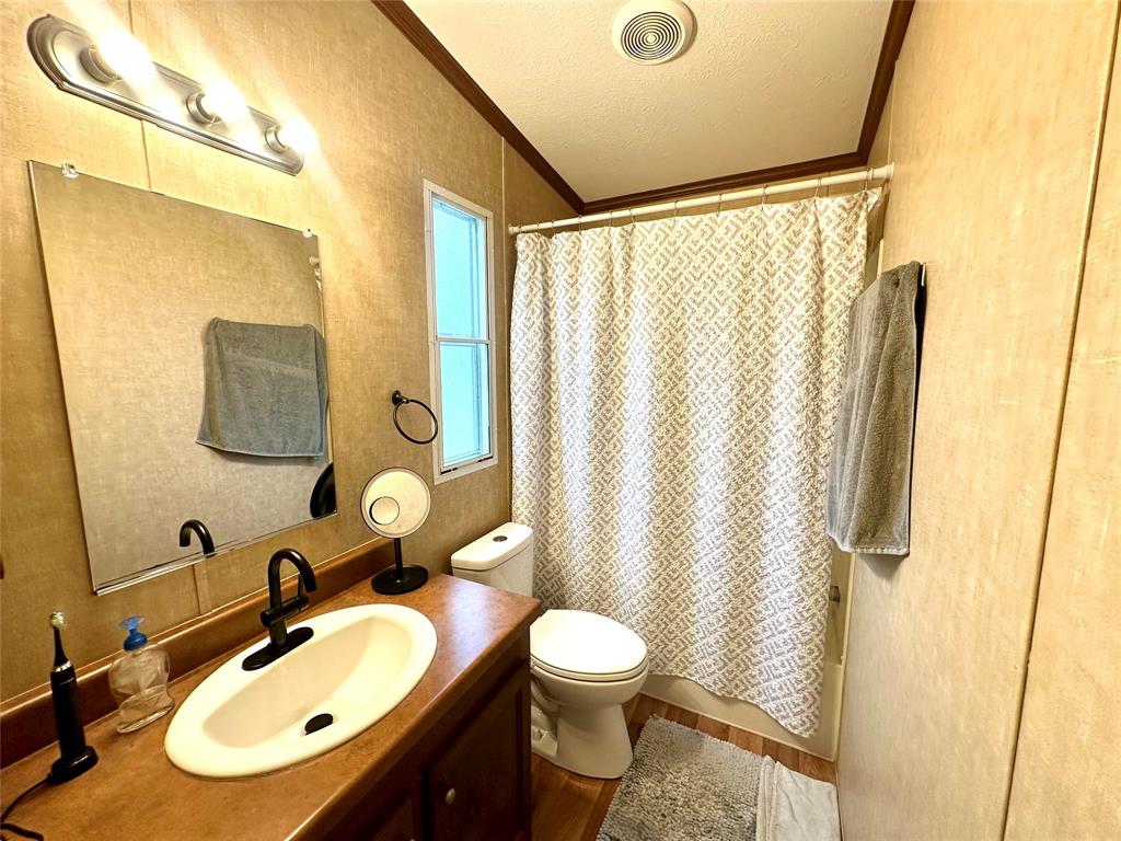 219 County Road 2723 Decatur, TX 76234 - Photo 23 of 26 a bathroom with a sink and a mirror