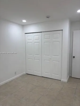 an empty room with closet area
