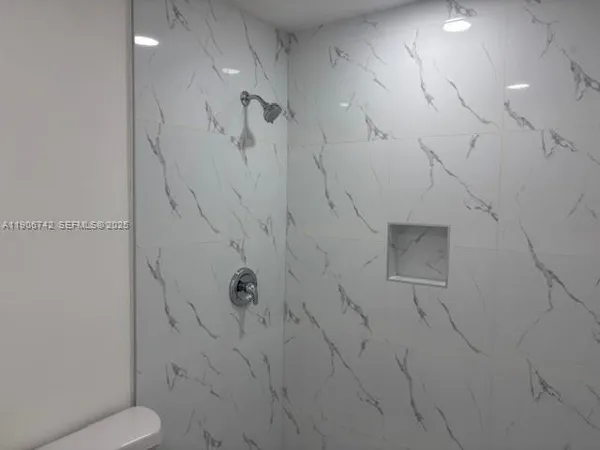 a bathroom with a toilet and a shower