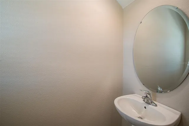 a bathroom with a sink and mirror