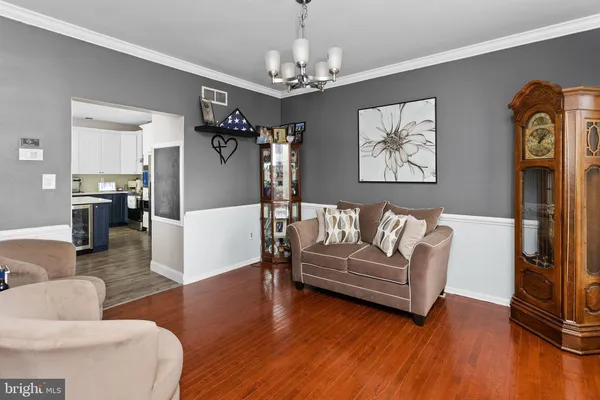 a living room with furniture and a chandelier