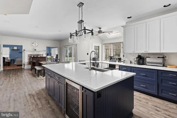 a open kitchen with stainless steel appliances granite countertop a sink a stove and a refrigerator