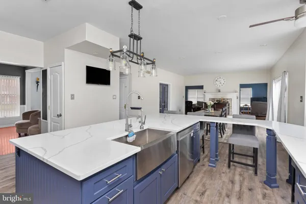 a kitchen with a stove a sink a dining table and chairs