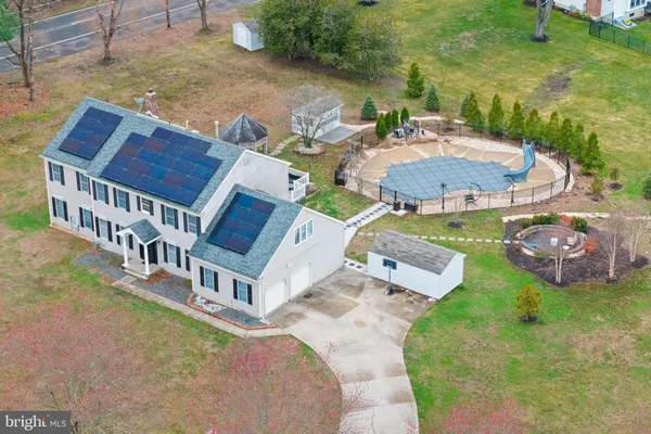 an aerial view of a house with garden space and street view
