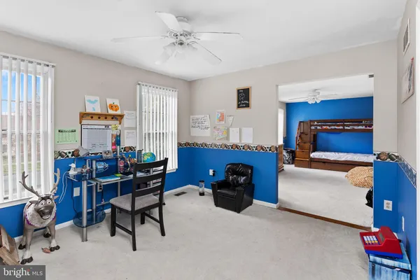 a bedroom with furniture and a window