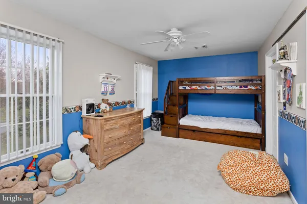 a bedroom with furniture and a flat screen tv