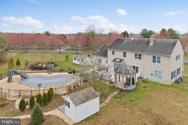 an aerial view of a house with a swimming pool