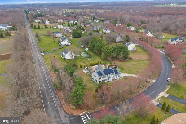 an aerial view of a house with a yard and lake view