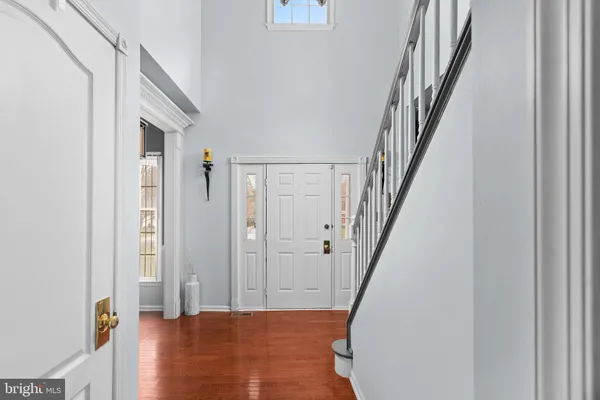 a view of a hallway with wooden floor and entryway