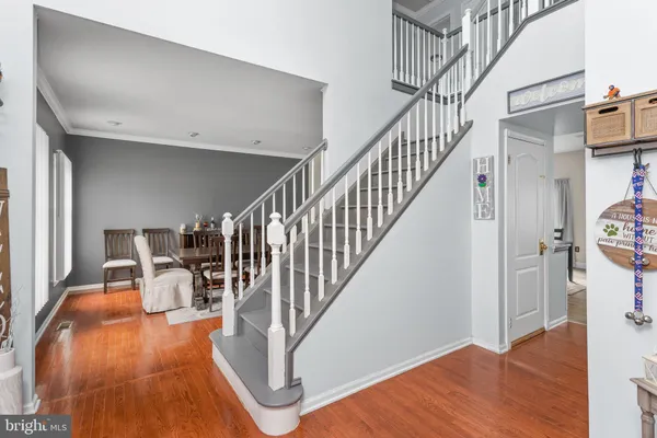 a view of entryway and hall with wooden floor