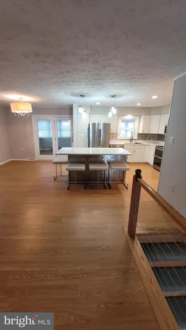 a kitchen with sink refrigerator and window