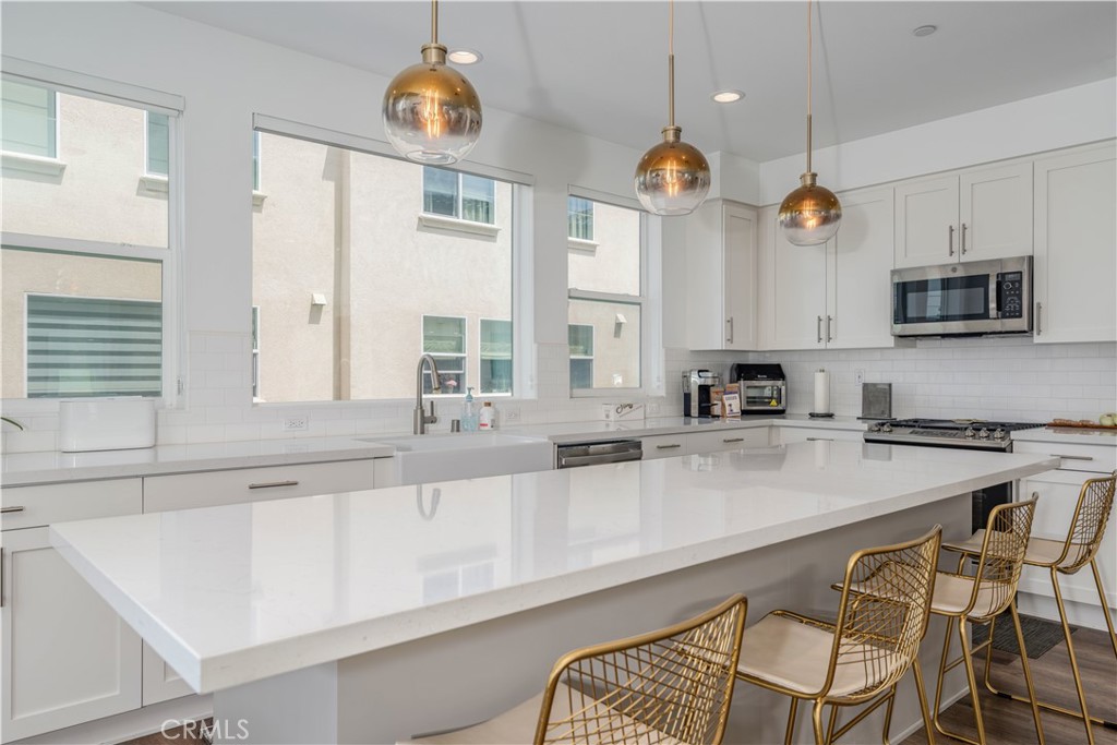 329 Ford Road Costa Mesa, CA 92627 - Photo 3 of 5 a kitchen with stainless steel appliances a stove a sink and cabinets