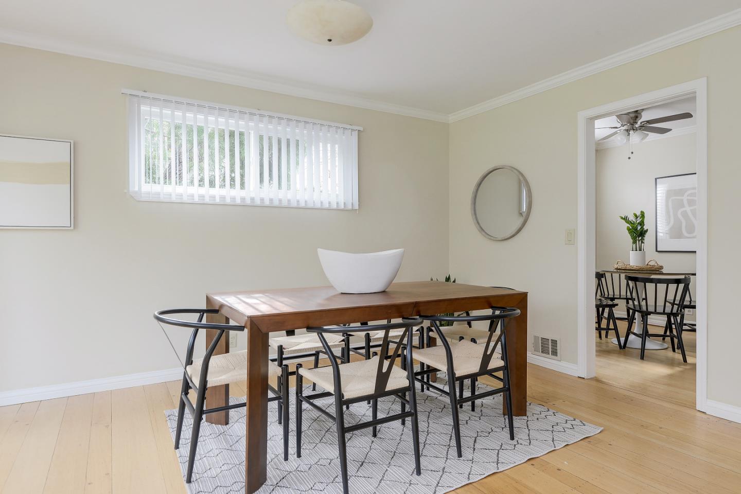 10510 Creston Drive Los Altos, CA 94024 - Photo 11 of 25 a view of a dining room and livingroom with furniture wooden floor and a rug