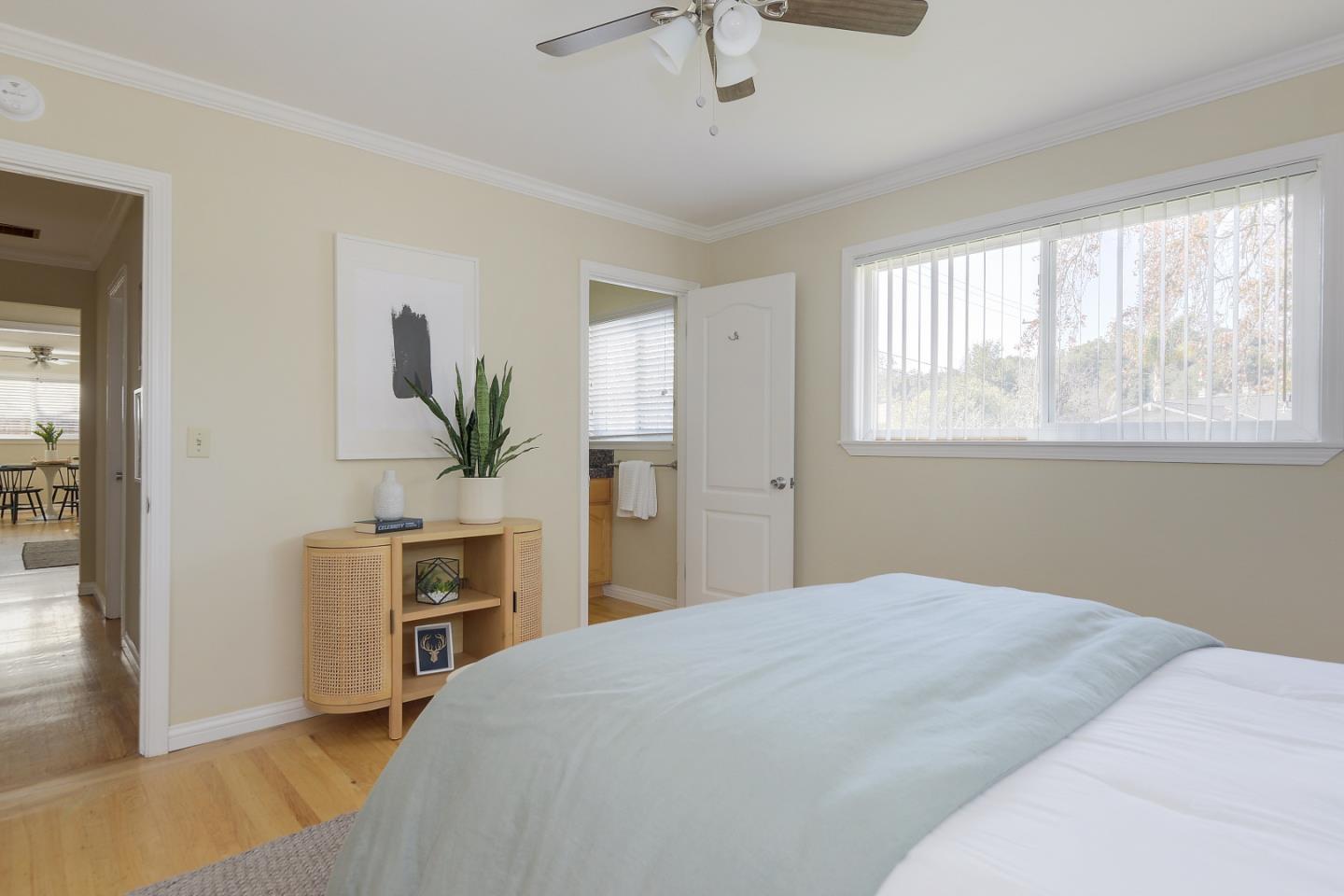 10510 Creston Drive Los Altos, CA 94024 - Photo 16 of 25 a bedroom with a large bed and a chandelier