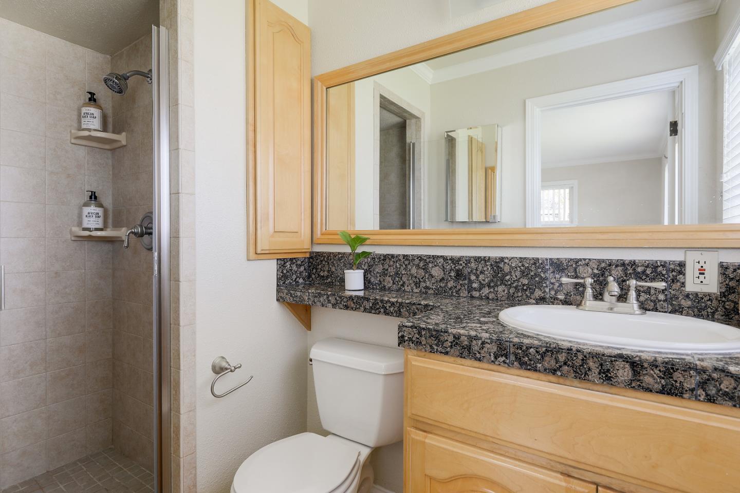 10510 Creston Drive Los Altos, CA 94024 - Photo 17 of 25 a bathroom with a granite countertop toilet sink and mirror
