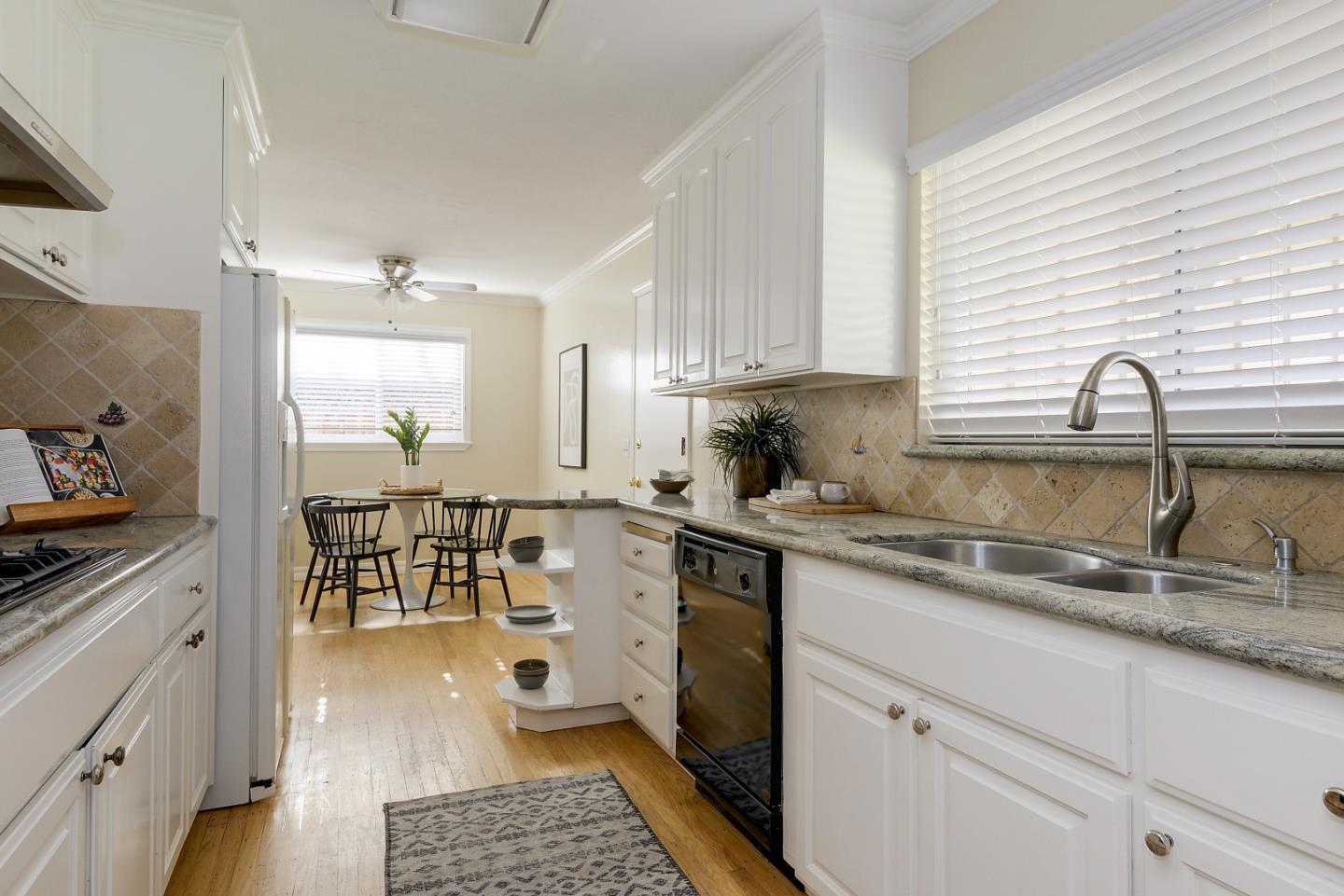 10510 Creston Drive Los Altos, CA 94024 - Photo 3 of 25 a kitchen with kitchen island granite countertop a sink a counter space appliances and cabinets