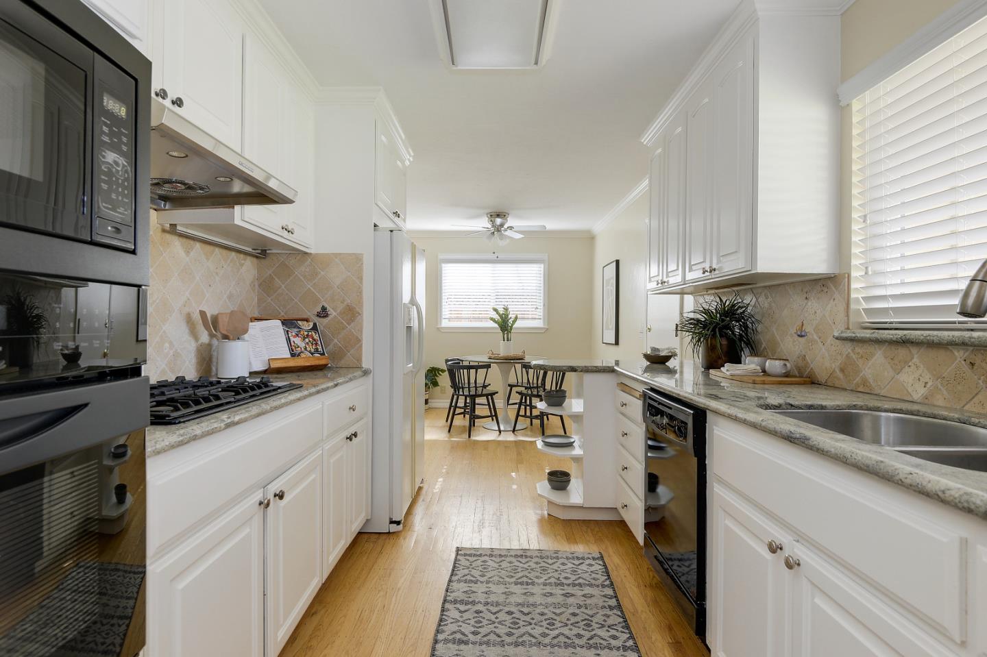 10510 Creston Drive Los Altos, CA 94024 - Photo 4 of 25 a kitchen with granite countertop a sink stove and cabinets