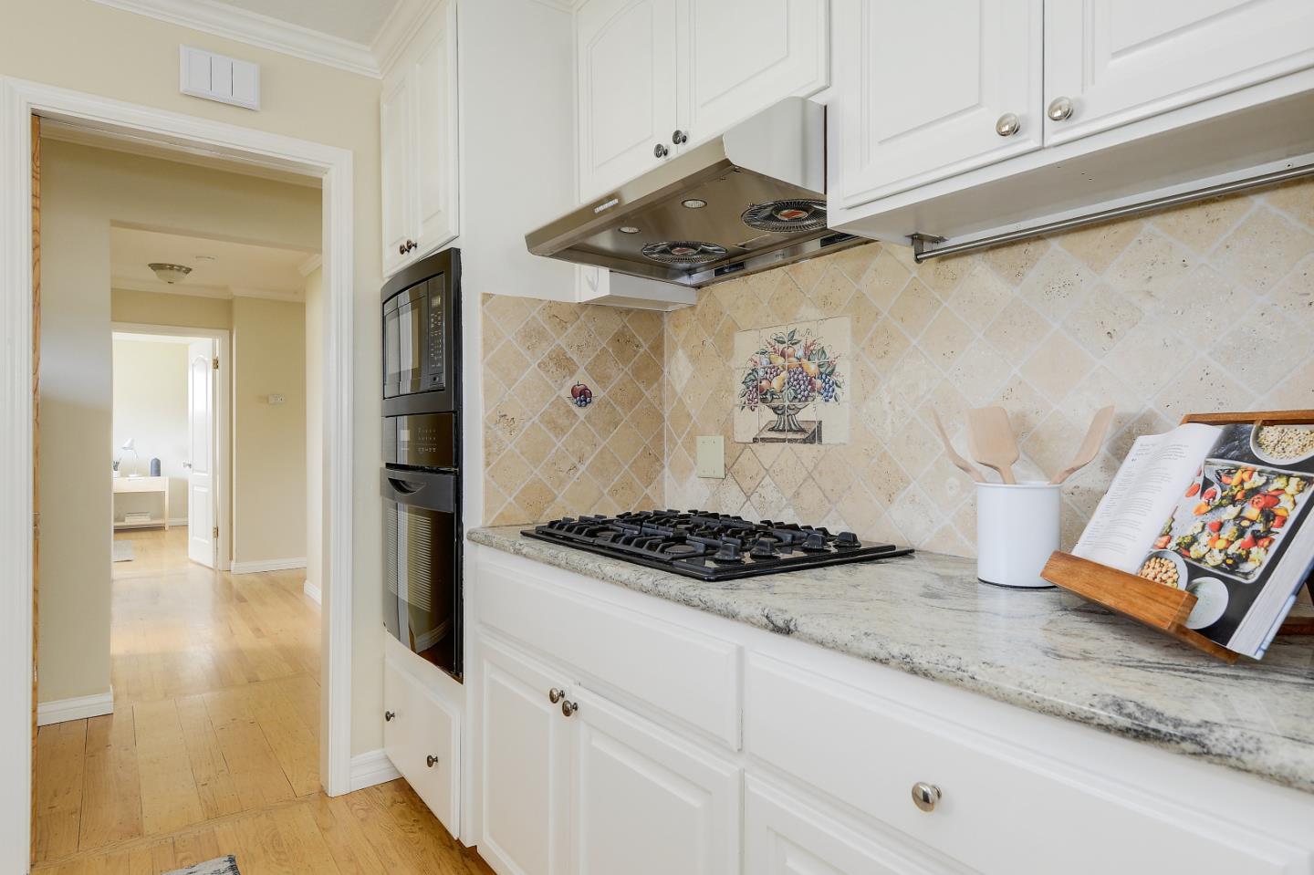 10510 Creston Drive Los Altos, CA 94024 - Photo 6 of 25 a kitchen with white cabinets and a stove