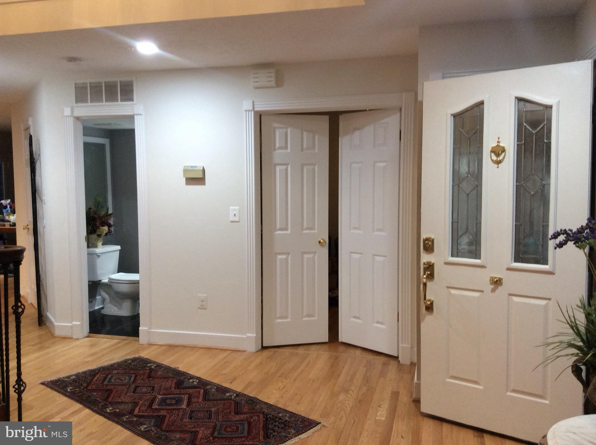 54 Rutherford Circle Sterling, VA 20165 - Photo 16 of 58 FOYER WITH VIEW OF POWDER ROOM AND LIBRARY DOORS
