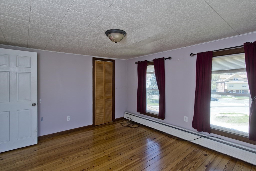 4 Laurel Street Chicopee, MA 01020 - Photo 19 of 35 an empty room with wooden floor and windows