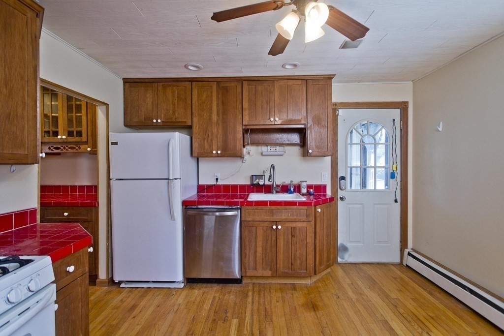 4 Laurel Street Chicopee, MA 01020 - Photo 4 of 35 a kitchen with a refrigerator and wooden floor