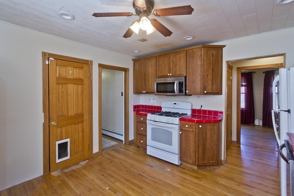 4 Laurel Street Chicopee, MA 01020 - Photo 5 of 35 a kitchen view of a kitchen island a stove and a microwave