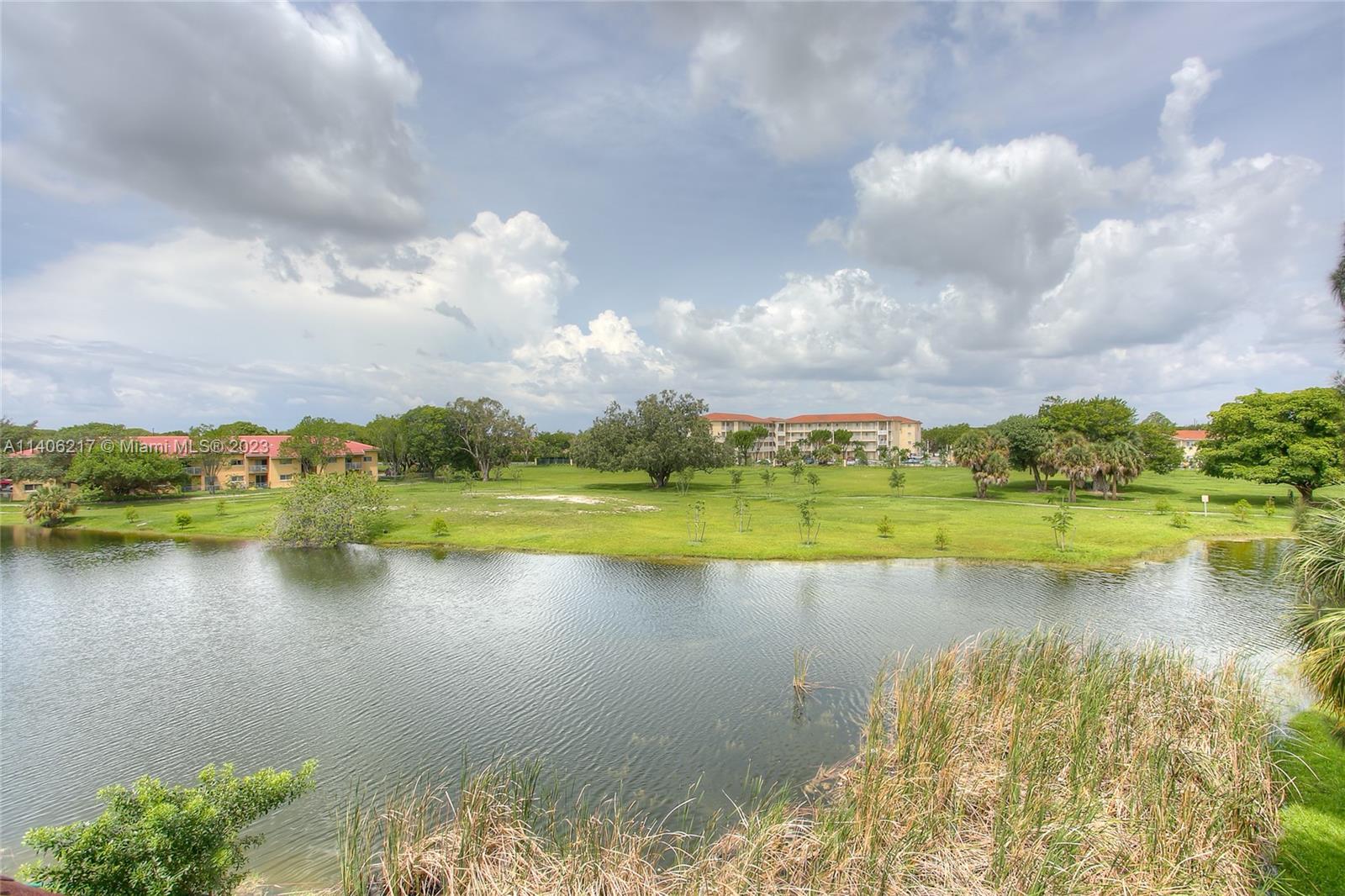17530 Northwest 68th Avenue, Unit C3010 Hialeah, FL 33015 - Photo 13 of 15 a view of a lake with a city