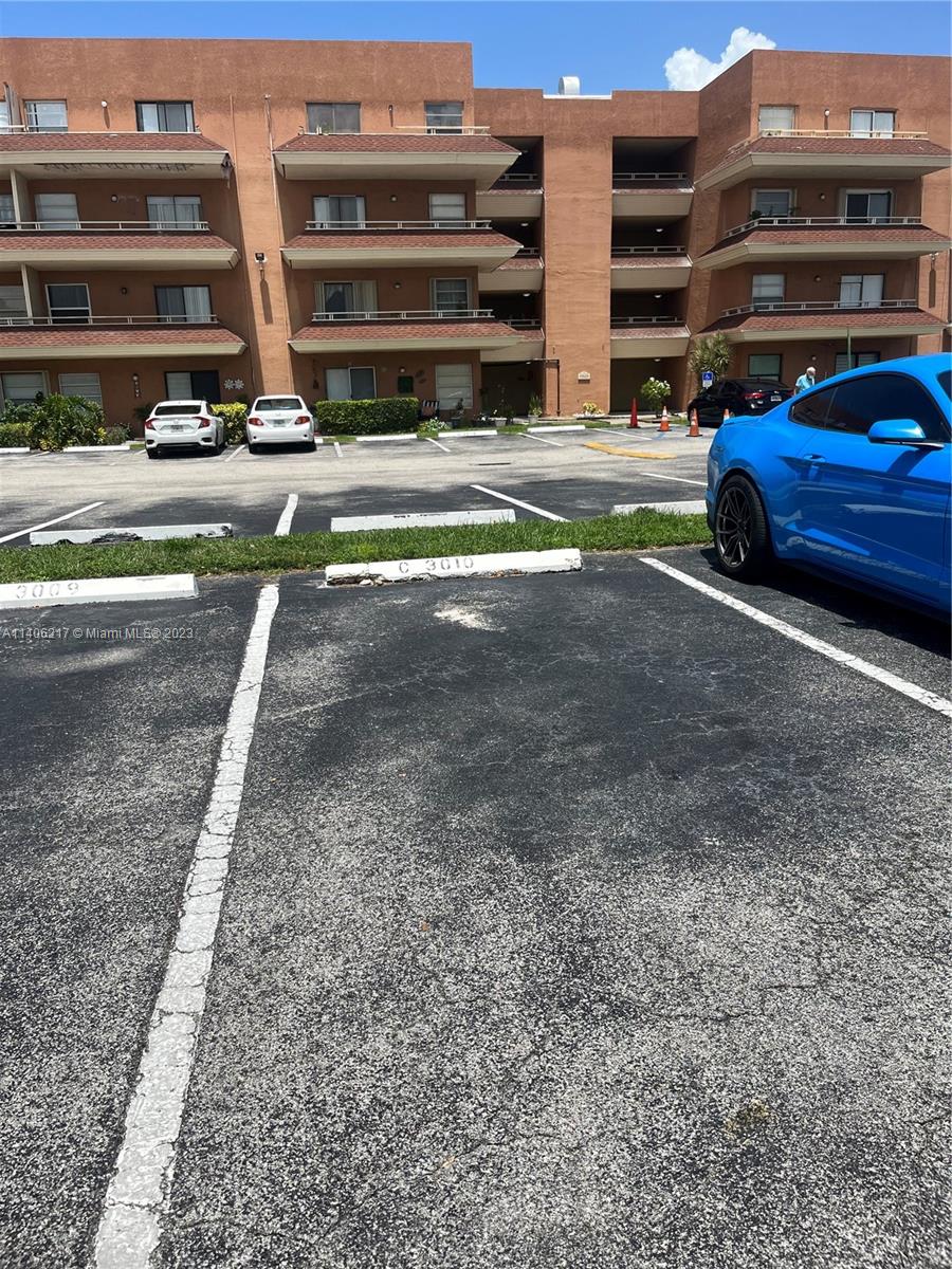 17530 Northwest 68th Avenue, Unit C3010 Hialeah, FL 33015 - Photo 14 of 15 a view of a car park in front of the house