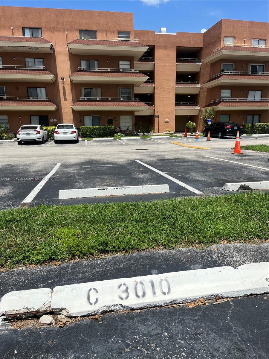 17530 Northwest 68th Avenue, Unit C3010 Hialeah, FL 33015 - Photo 15 of 15 a street with view of a building and trees in the background