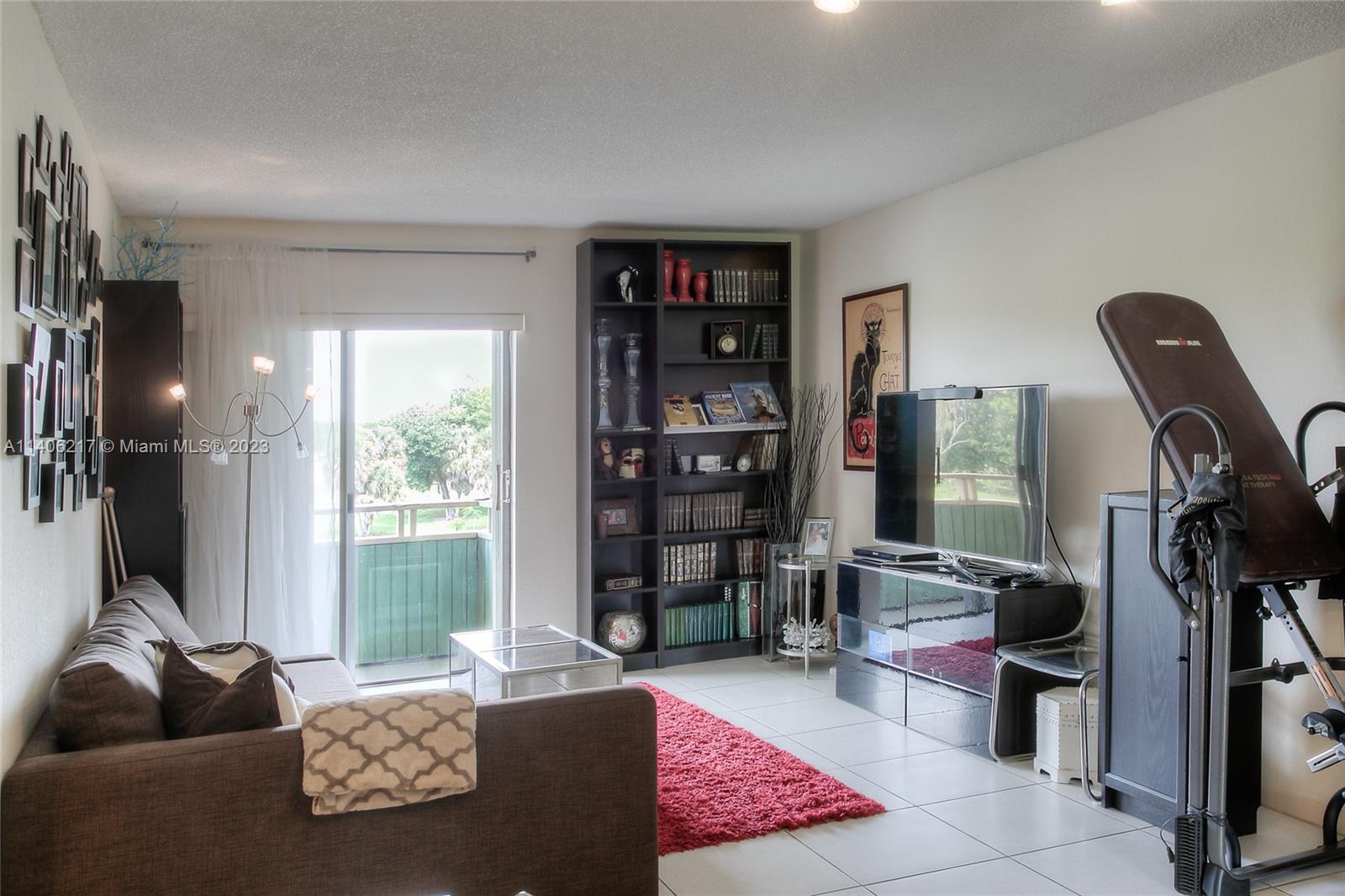 17530 Northwest 68th Avenue, Unit C3010 Hialeah, FL 33015 - Photo 3 of 15 a living room with furniture and floor to ceiling window