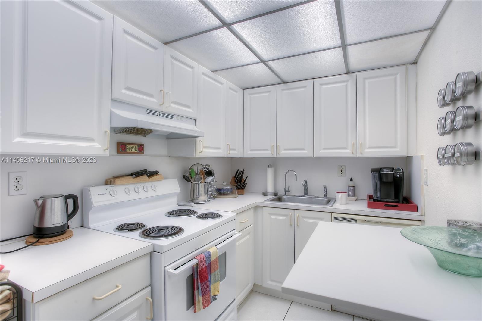 17530 Northwest 68th Avenue, Unit C3010 Hialeah, FL 33015 - Photo 8 of 15 a kitchen with cabinets appliances a sink and a counter top space