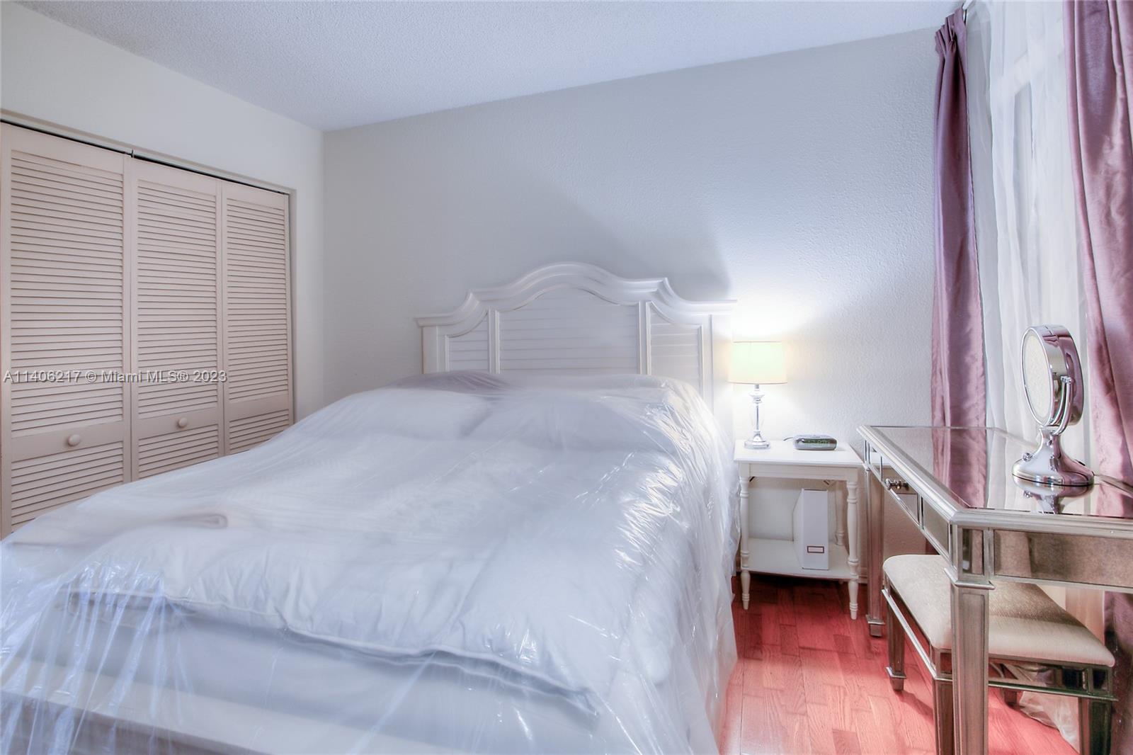 17530 Northwest 68th Avenue, Unit C3010 Hialeah, FL 33015 - Photo 10 of 15 a spacious bedroom with a bed and a cabinets