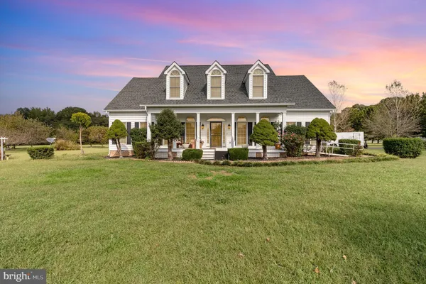 a front view of a house with a yard table and chairs